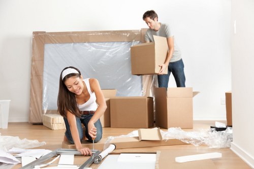 Man With A Van Kingston team handling items safely with protective gear