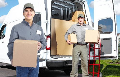 Driver and helper preparing items for safe delivery