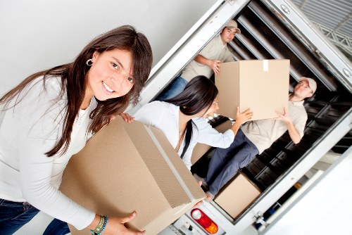 Movers navigating stair access during flat removals in Kingston