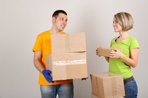 Removal workers loading furniture into a van for a Kingston home relocation